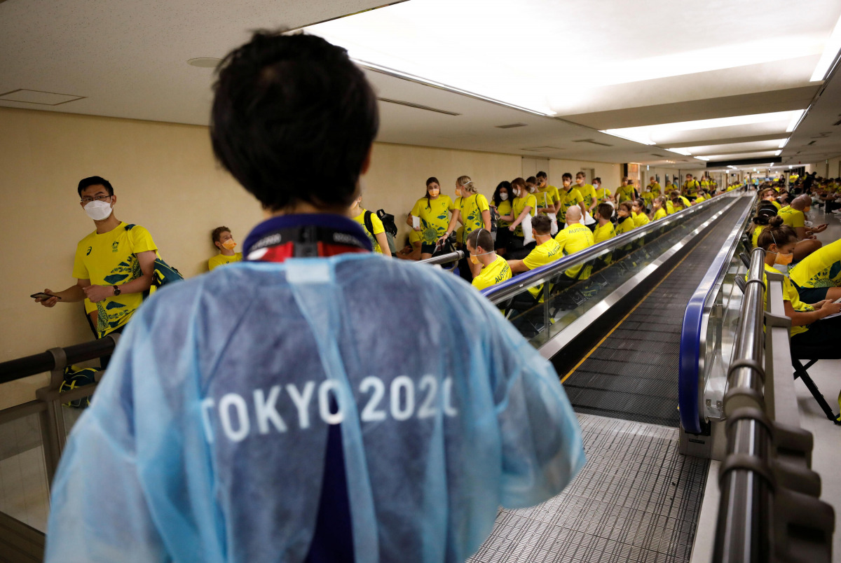 FILE PHOTO: Members of Australian team wait to take the quantitative coronavirus disease (COVID-19) antigen test after arriving at Narita International Airport ahead of Tokyo 2020 Olympic Games, in Narita, east of Tokyo, Japan July 17, 2021. REUTERS/Issei