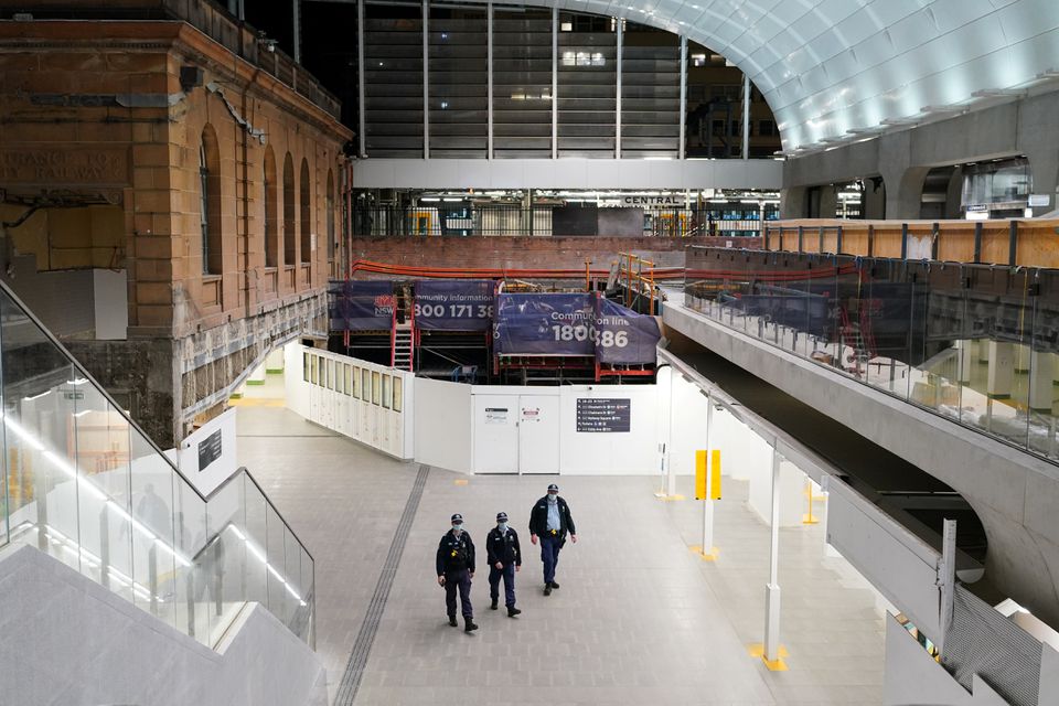 Police officers patrol through the quiet Central Station in the city centre during a lockdown to curb the spread of a coronavirus disease (COVID-19) outbreak in Sydney, Australia, August 12, 2021. REUTERS/Loren Elliott