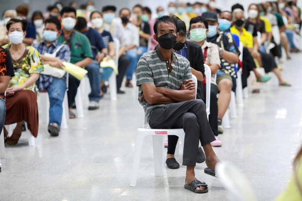 People queue at the Central Vaccination Center as Thailand opens walk-in for first dose of the AstraZeneca vaccination scheme for elders, people with a minimum weight of 100 kilograms and pregnant women amid the coronavirus (COVID-19) outbreak in Bangkok,