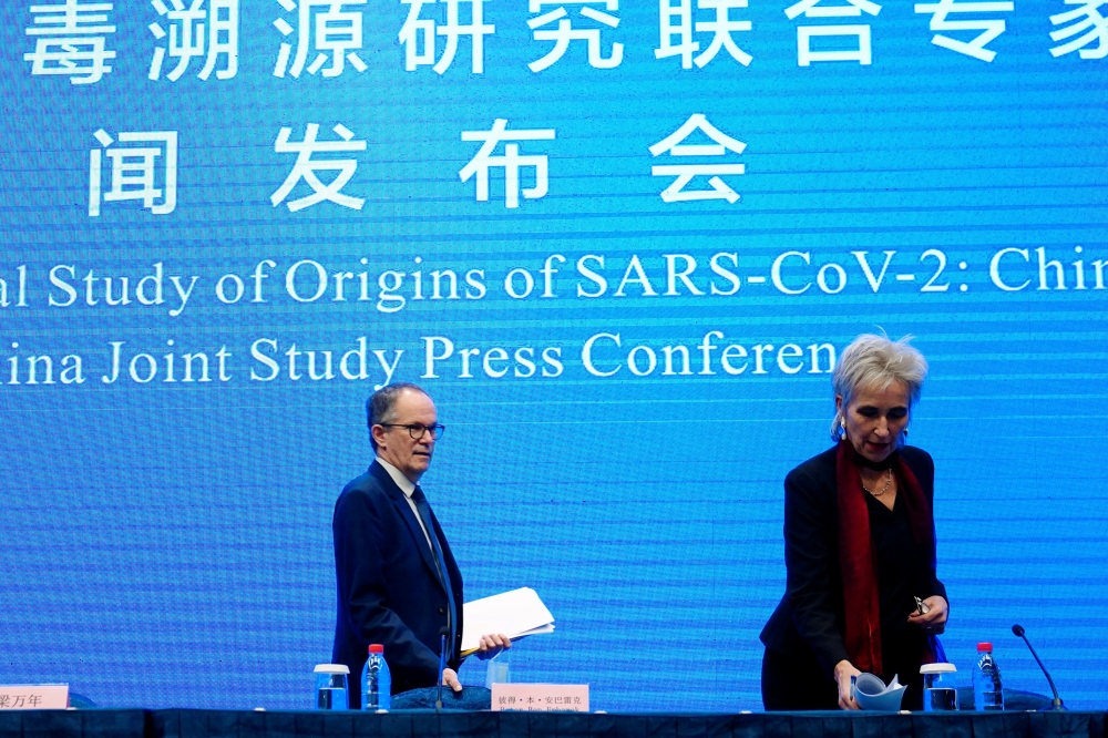Peter Ben Embarek and Marion Koopmans, members of the World Health Organization (WHO) team tasked with investigating the origins of the coronavirus disease (COVID-19), arrive for the WHO-China joint study news conference at a hotel in Wuhan, Hubei provinc