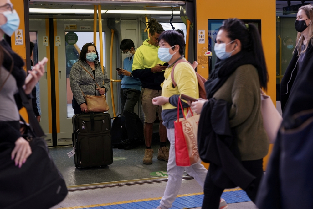 Commuters wear protective face masks on public transit at Central Station following the implementation of new public health regulations from the state of New South Wales, as the city grapples with an outbreak of the coronavirus disease (COVID-19) in Sydne