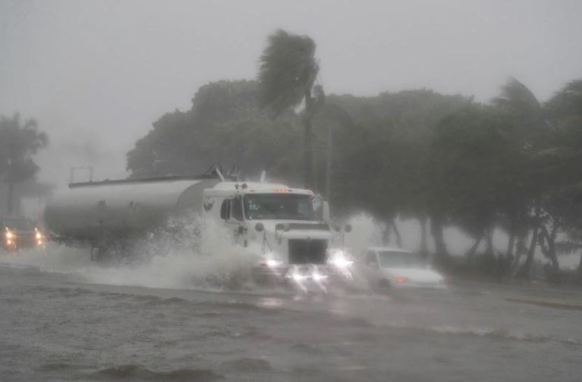 Vehicles move through a flooded street during the passage of Tropical Storm Fred in Santo Domingo, Dominican Republic August 11, 2021. REUTERS/Ricardo Rojas

