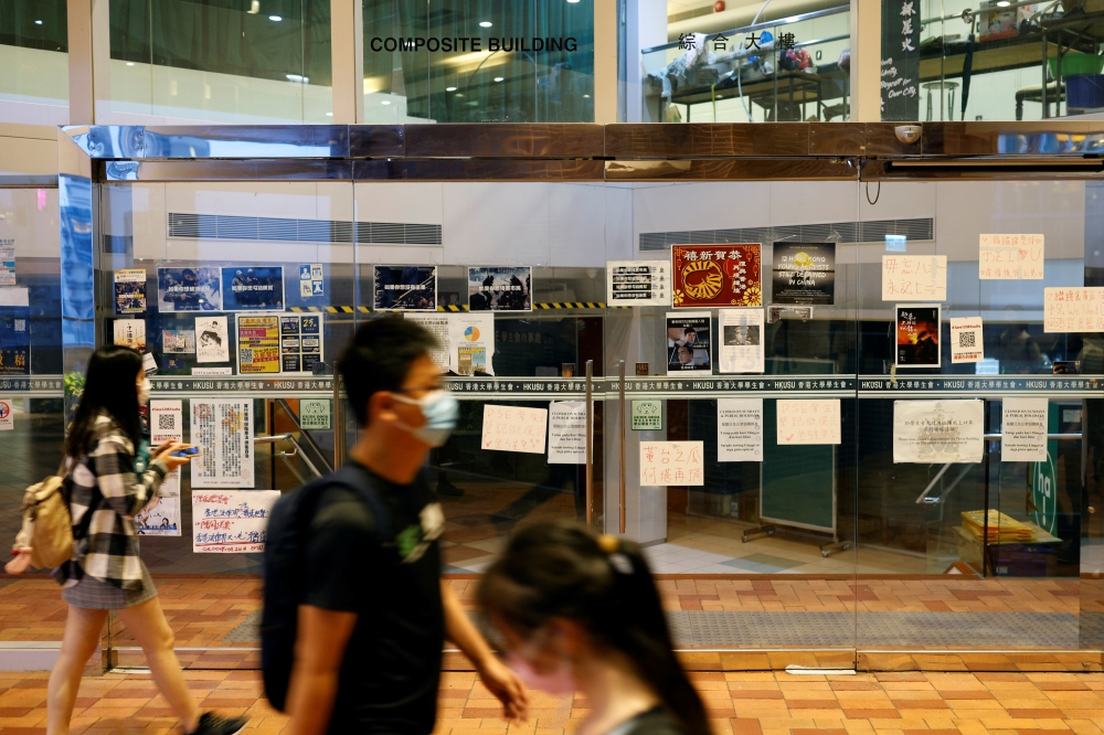 Student walk past the Hong Kong University Students' Union (HKUSU) office at the Hong Kong University in Hong Kong, China May 2, 2021. Reuters/Tyrone Siu
