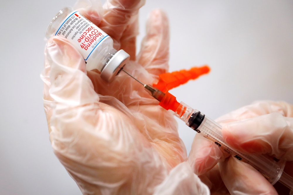 FILE PHOTO: A healthcare worker prepares a syringe with the Moderna COVID-19 Vaccine at a pop-up vaccination site operated by SOMOS Community Care during the COVID-19 pandemic in Manhattan in New York City, New York, U.S., January 29, 2021. REUTERS/Mike S