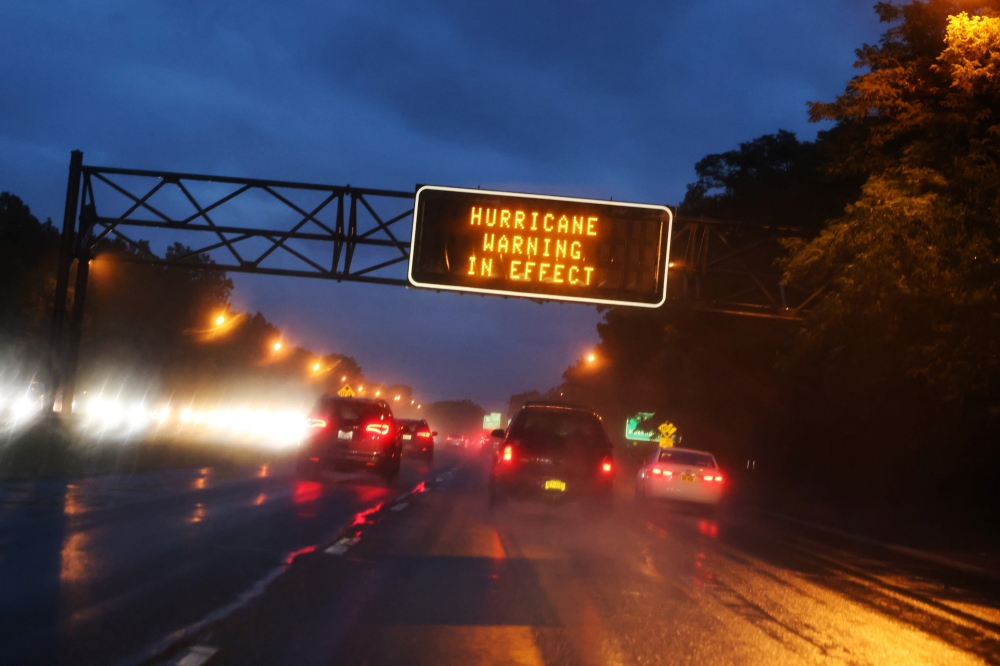 Signs on the highway warn commuters not to travel on Sunday as Hurricane Henri approaches in Long Island, New York, U.S., August 21, 2021. REUTERS/Caitlin Ochs