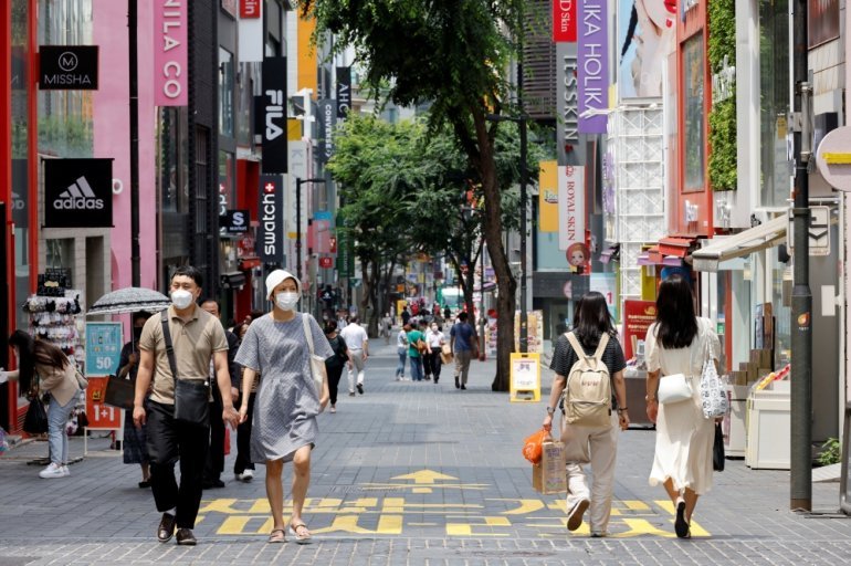 People wearing masks walk in a shopping district amid the coronavirus disease (COVID-19) pandemic in Seoul, South Korea, July 9, 2021. REUTERS/ Heo Ran/File Photo
