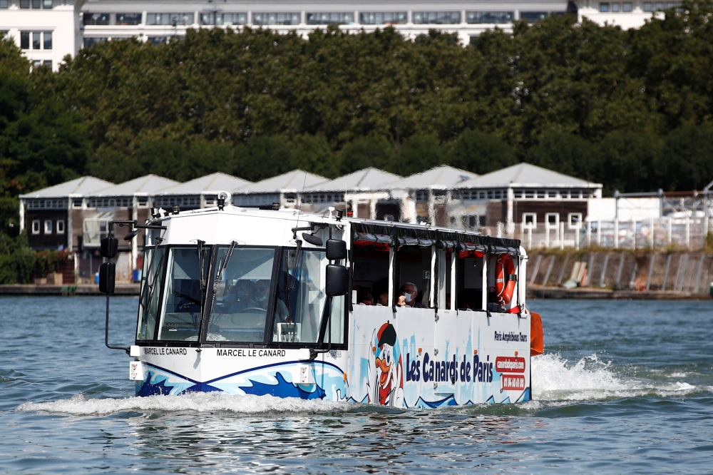 An amphibious bus named Marcel le Canard (Marcel The Duck) sails down the Seine river during a tour around Paris, in Sevres near Paris, France, August 25, 2021. Picture taken August 25, 2021. REUTERS/Sarah Meyssonnier