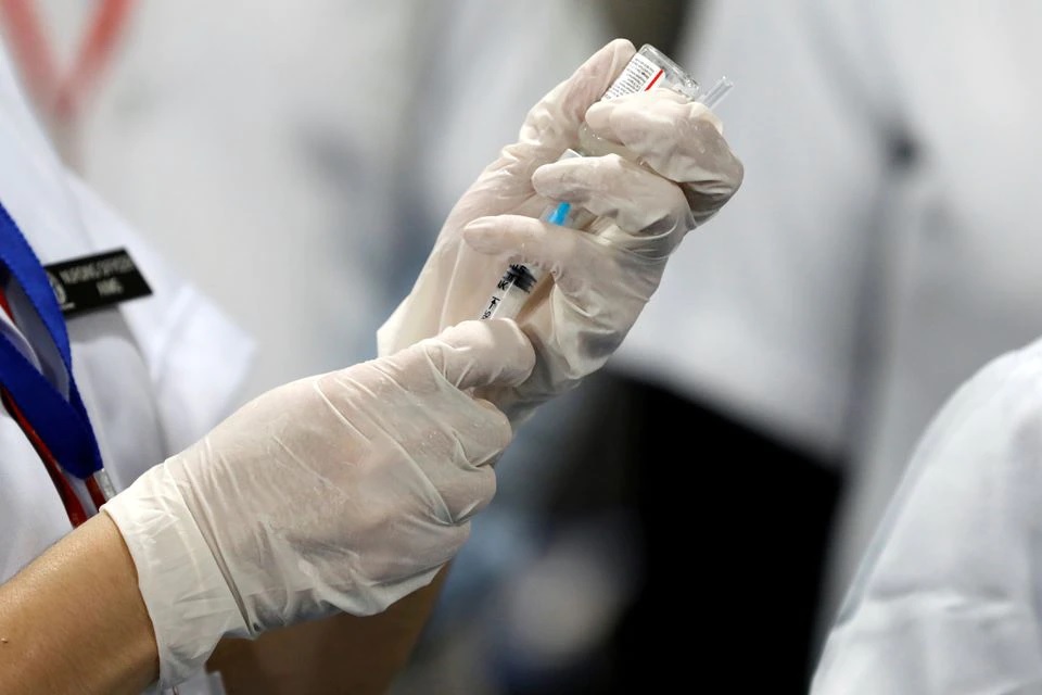 A healthcare worker fills a syringe with a dose of Bharat Biotech's COVID-19 vaccine called COVAXIN, during the coronavirus disease (COVID-19) vaccination campaign at All India Institute of Medical Sciences (AIIMS) hospital in New Delhi, India, January 16