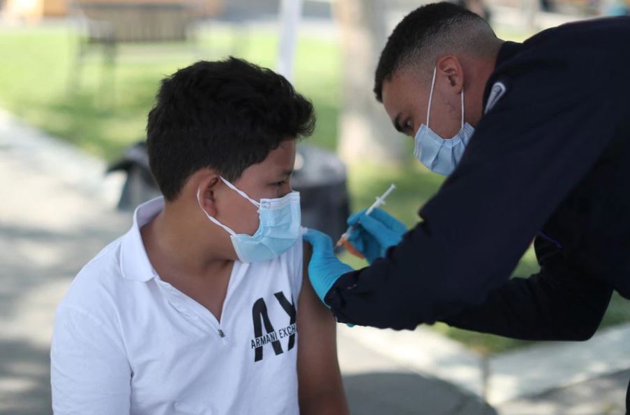 Alessandro Roque, 12, receives a coronavirus disease (COVID-19) vaccination as part of a vaccine drive by the Fernandeno Tataviam Band of Mission Indians in Arleta, Los Angeles, California, U.S., August 23, 2021. REUTERS/Lucy Nicholson

