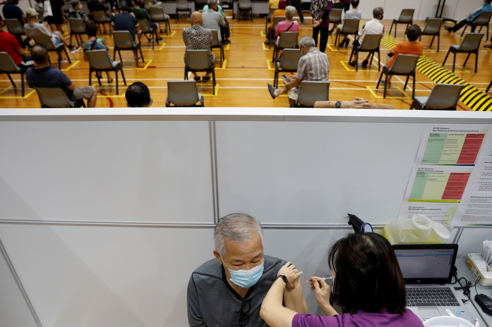 A man receives his vaccination at a coronavirus disease (COVID-19) vaccination center in Singapore March 8, 2021. REUTERS/Edgar Su/File Photo