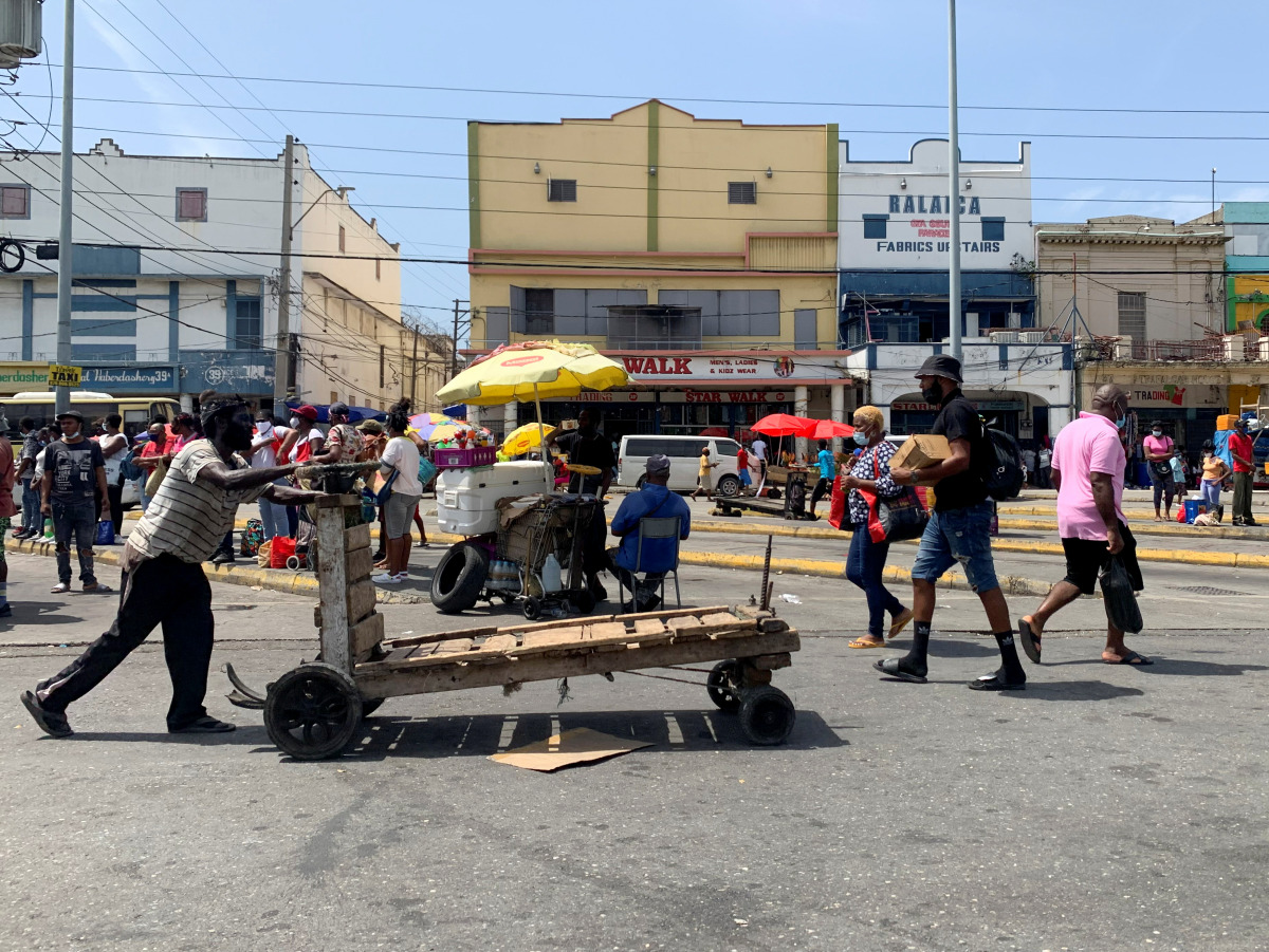 A man pushes a trolley in a busy market amid the coronavirus pandemic, in downtown Kingston, Jamaica September 2, 2021. Picture taken September 2, 2021. REUTERS/Kate Chappell 
