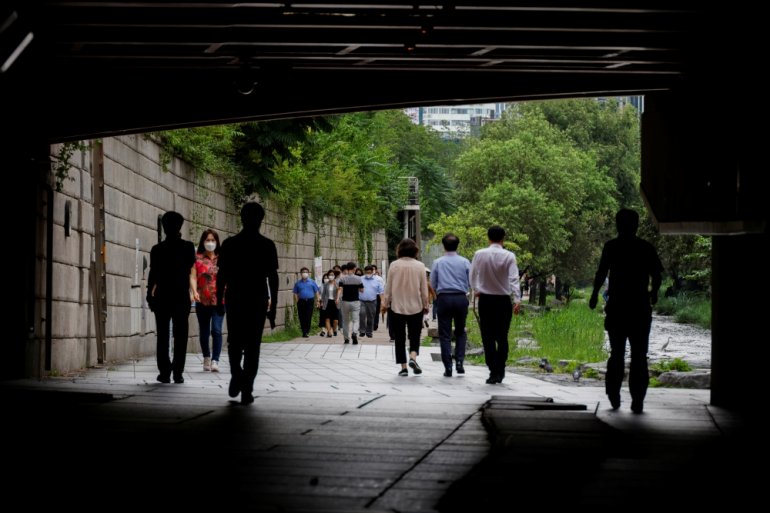 People wearing masks take a walk amid the coronavirus disease (COVID-19) pandemic in Seoul, South Korea, July 7, 2021. REUTERS/ Heo Ran