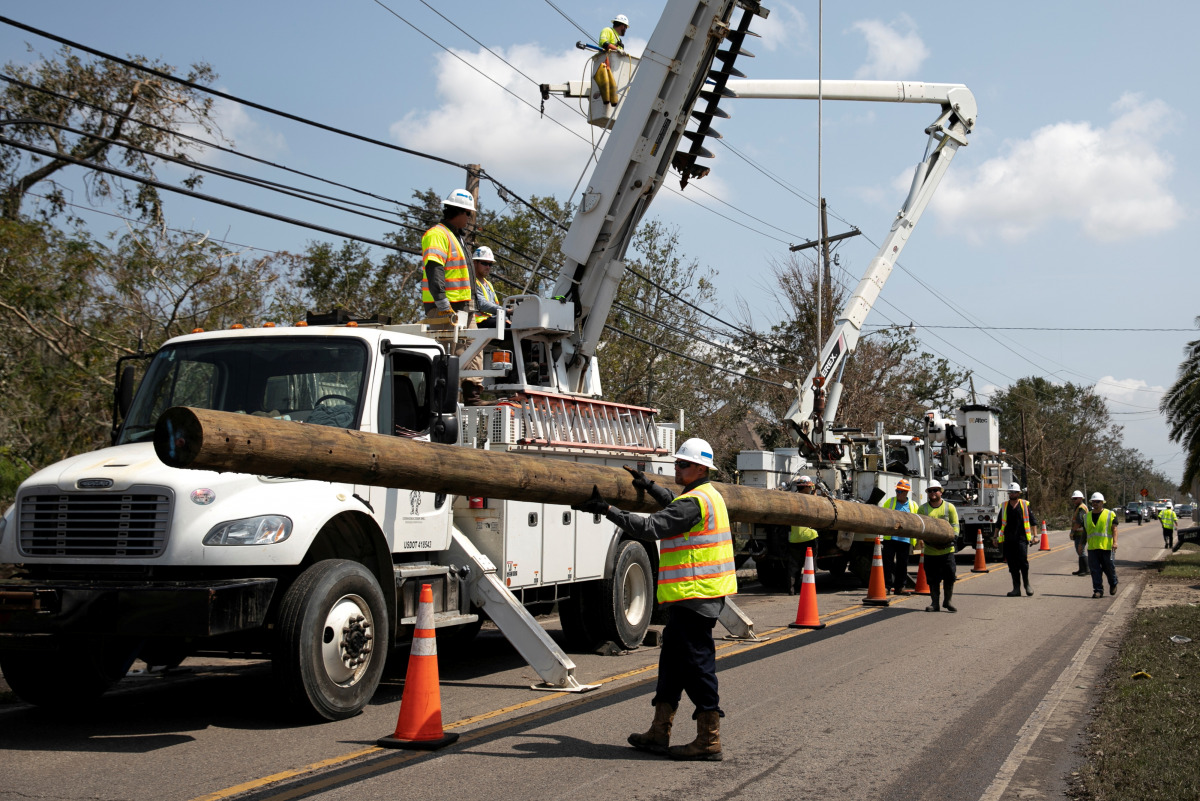 FILE PHOTO: Power restoration workers are seen in the aftermath of Hurricane Ida landfall in Louisiana, in Jean Lafitte, Louisiana, U.S. September 2, 2021. REUTERS/Marco Bello/File Photo
