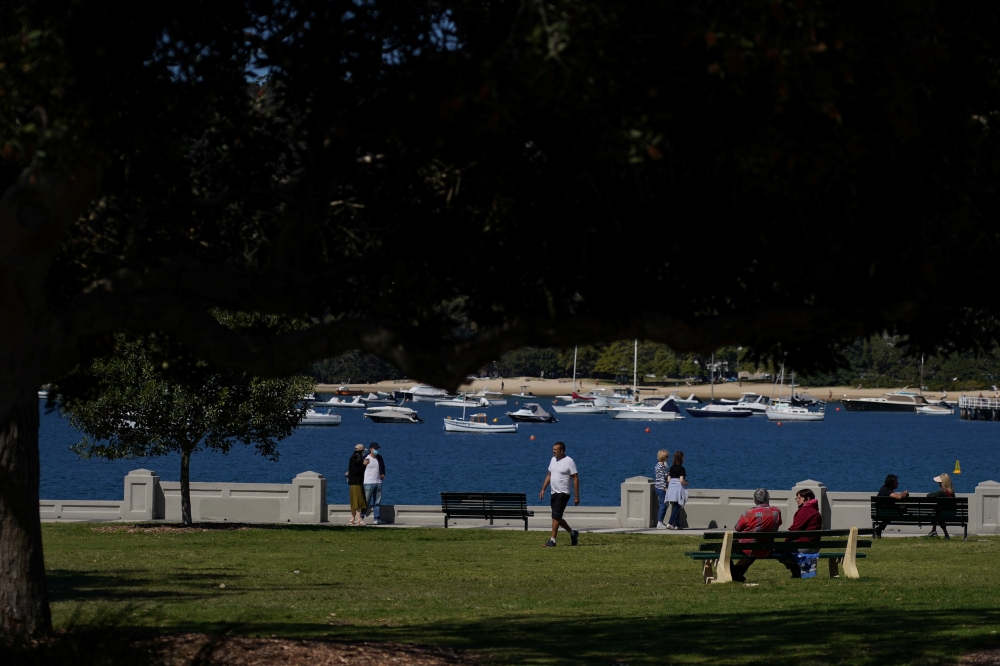 People enjoy a sunny day next to Balmoral Beach during a lockdown to curb the spread of a coronavirus disease (COVID-19) outbreak in Sydney, Australia, September 8, 2021. REUTERS/Loren Elliott