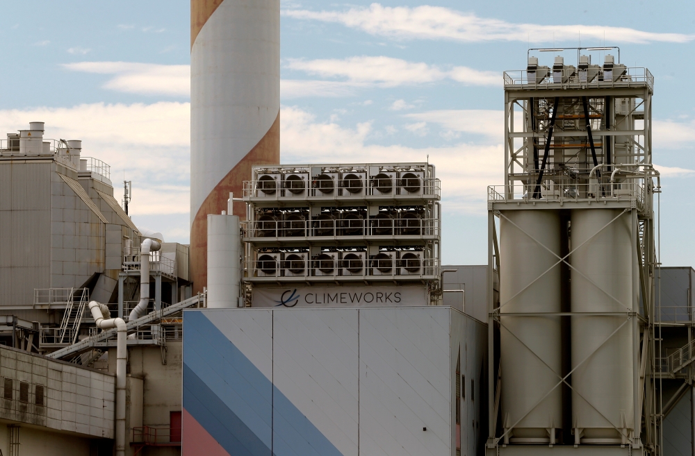 File photo: A facility for capturing CO2 from air of Swiss Climeworks AG is placed on the roof of a waste incinerating plant in Hinwil, Switzerland July 18, 2017. REUTERS/Arnd Wiegmann/File Photo