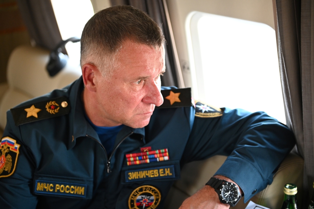 Russia's Emergencies Minister Yevgeny Zinichev sits in a helicopter as he accompanies President Vladimir Putin in a flight over wildfires sites in Chelyabinsk region, Russia August 6, 2021. Picture taken August 6, 2021. Sputnik/Alexei Nikolsky/Kremlin via
