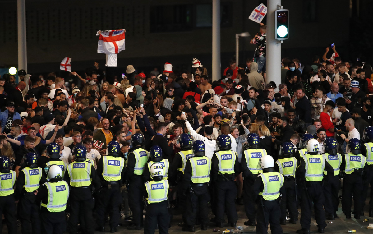 FILE PHOTO: Soccer Football - Euro 2020 - Final - Fans gather for Italy v England - Wembley Stadium, London, Britain - July 11, 2021 Police officers stand guard as England fans gather outside Wembley Stadium during the match Action Images via Reuters/Pete