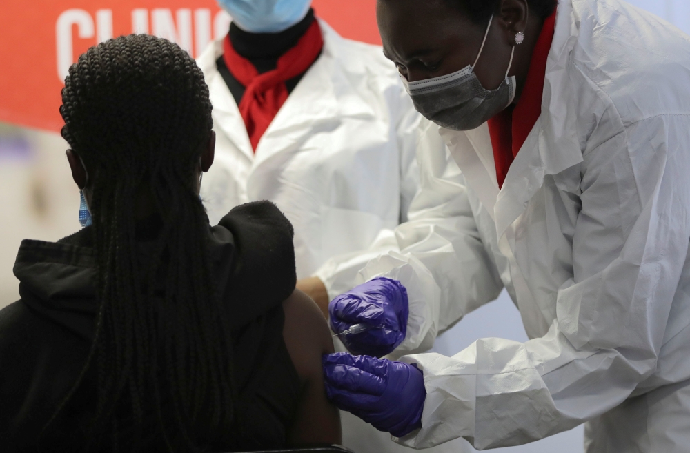 A health worker administers a vaccine during the launch of the South African leg of a global Phase III trial of Sinovac's coronavirus disease (COVID-19) vaccine in children and adolescents, in Pretoria, South Africa, September 10, 2021. REUTERS/Siphiwe Si