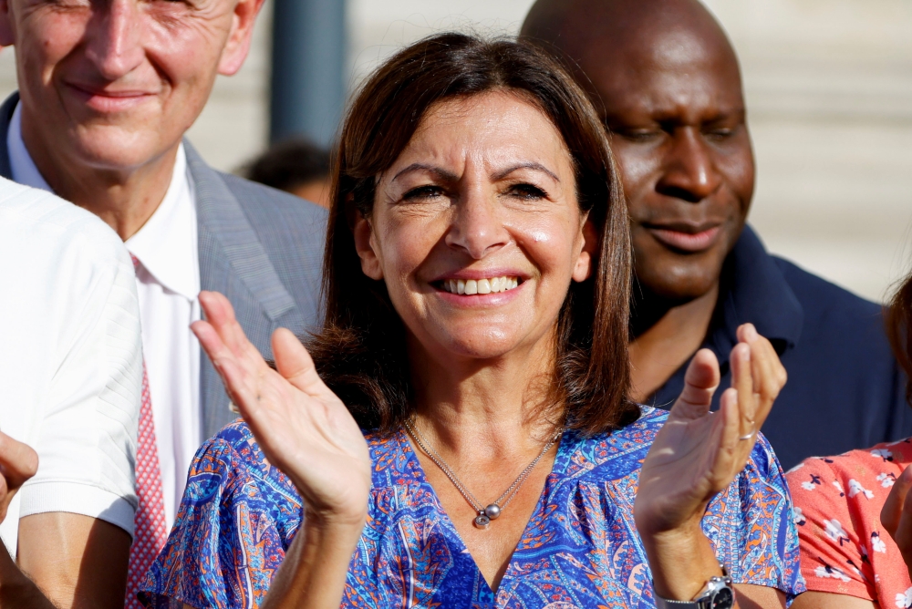 File photo: Mayor of Paris Anne Hidalgo applauds as she attends a ceremony with the French Paralympic delegation, in front of the city hall in Paris, France, September 6, 2021. REUTERS/Eric Gaillard/File Photo
