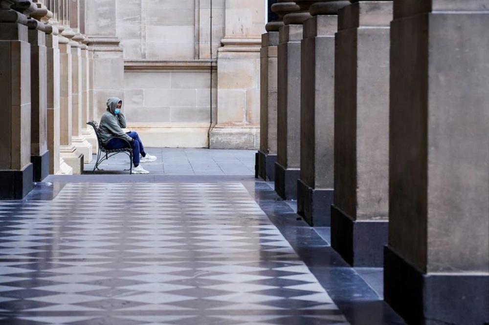 A lone man wearing a protective face mask sits at an unusually quiet State Library on the first day of a lockdown as the state of Victoria looks to curb the spread of a coronavirus disease (COVID-19) outbreak in Melbourne, Australia, July 16, 2021. REUTER