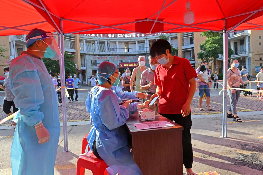 Residents register to take nucleic acid tests at a testing site in Quanzhou, following new cases of the coronavirus disease (COVID-19), in Fujian province, China September 13, 2021. China Daily via REUTERS 