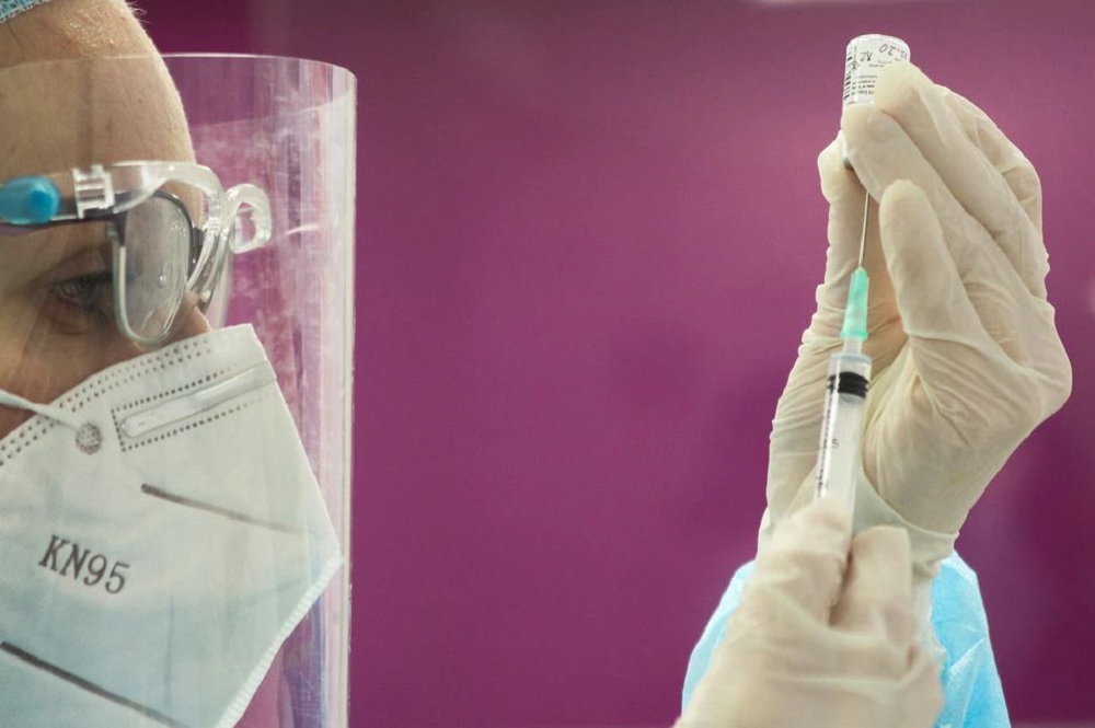 A health care worker prepares a Pfizer-BioNTech COVID-19 vaccine at a home for elders as the country begins vaccinations against coronavirus disease, in Domzale, Slovenia December 27, 2020. REUTERS/Srdjan Zivulovic