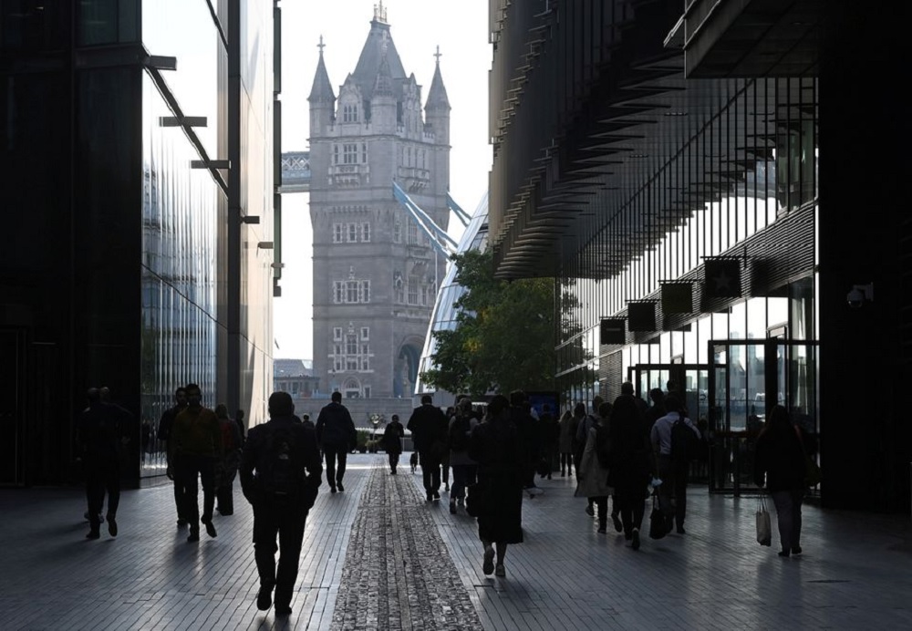 Workers walk towards Tower Bridge during the morning rush hour, amid a relaxation of lockdown restrictions during the coronavirus disease (COVID-19) pandemic in London, Britain, September 15, 2021. REUTERS/Toby Melville