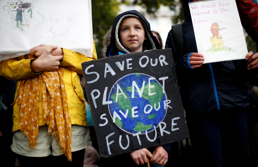File photo: A child carries a sign during an Extinction Rebellion demonstration in London, Britain, October 12, 2019. Reuters/Henry Nicholls/File Photo
