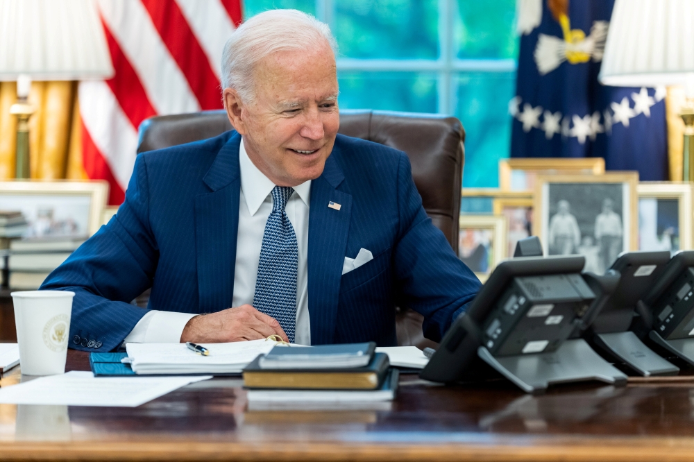 US President Joe Biden speaks on the phone with French President Emmanuel Macron from the Oval Office of the White House in this official White House handout photo released after the call in Washington, U.S., September 22, 2021. Adam Schultz/The White Hou