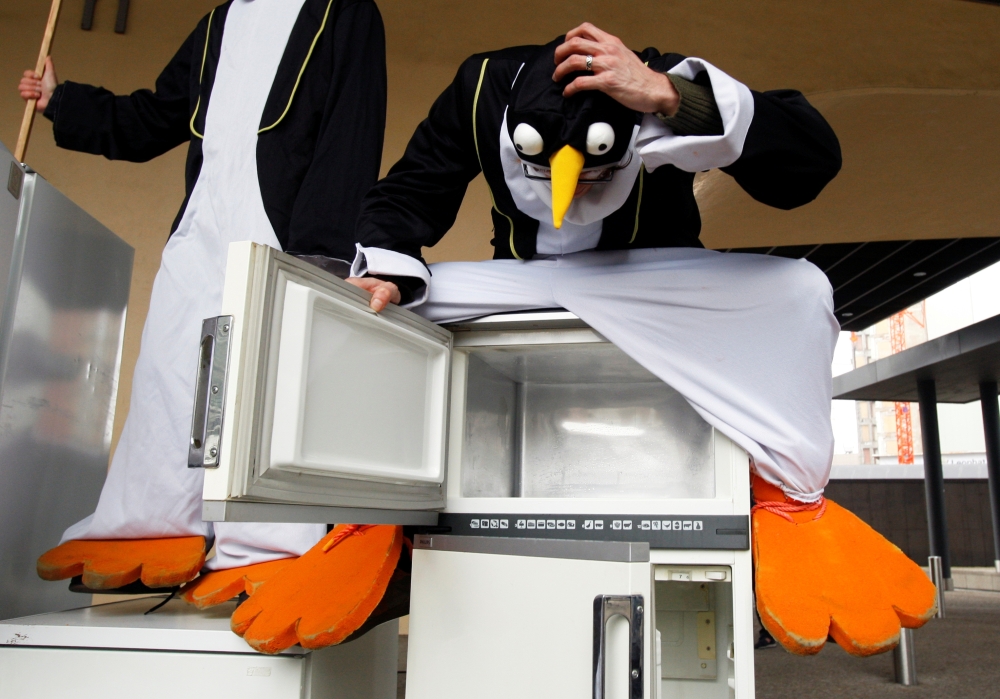 File photo: Climate activists dressed as penguins sit on refrigerators during a protest outside the European Commission headquarters in Brussels, March 12, 2009. Reuters/Francois Lenoir (Belgium) /File Photo