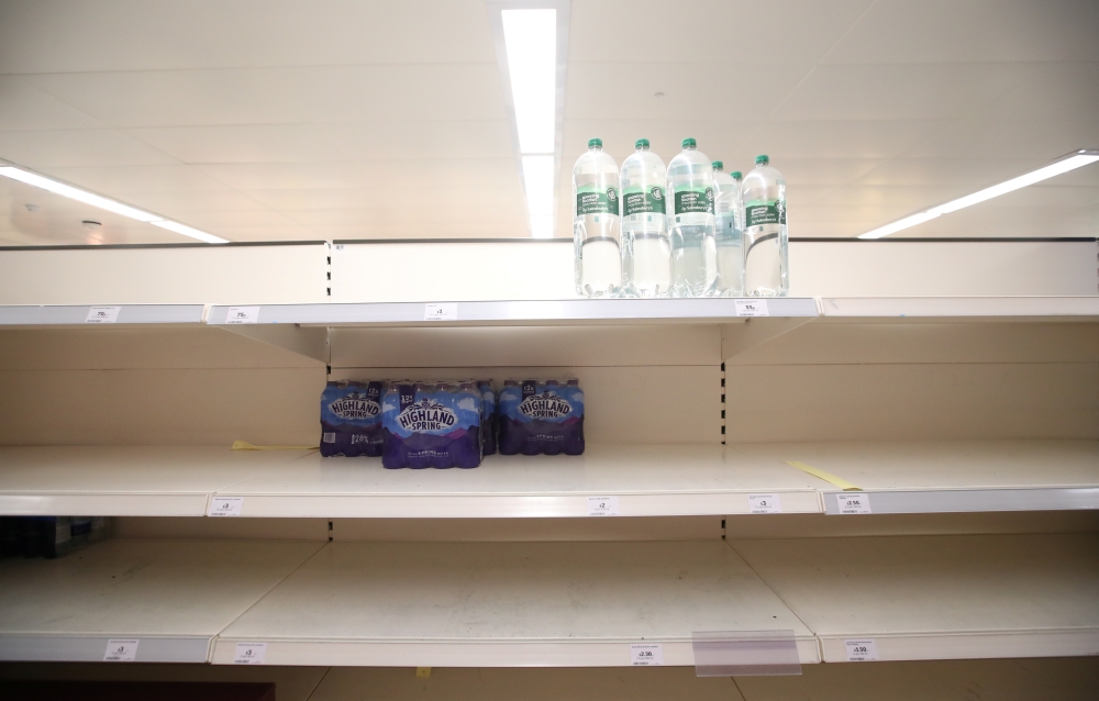 Empty shelves are seen in the soft drinks aisle of Sainsbury's supermarket, Harpenden, Britain, September 22, 2021. REUTERS/Peter Cziborra