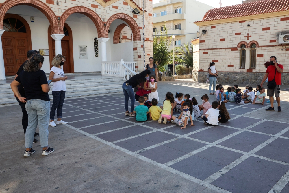 Students and their teachers are seen at a square following an earthquake in Heraklion, on the island of Crete, Greece, September 27, 2021. REUTERS/Stefanos Rapanis