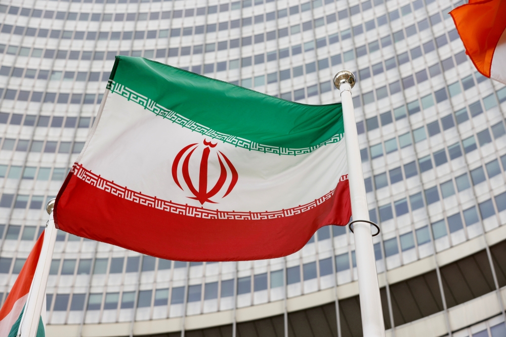 File photo: The Iranian flag waves in front of the International Atomic Energy Agency (IAEA) headquarters in Vienna, Austria May 23, 2021. Reuters/Leonhard Foeger/File Photo