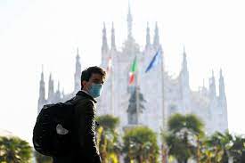 A man wearing a mask walks in the Duomo square as Lombardy tightens restrictions due to a surge in the number of the coronavirus disease (COVID-19) infections in the region, in Milan, Italy, March 5, 2021. REUTERS/Flavio Lo Scalzo/File Photo