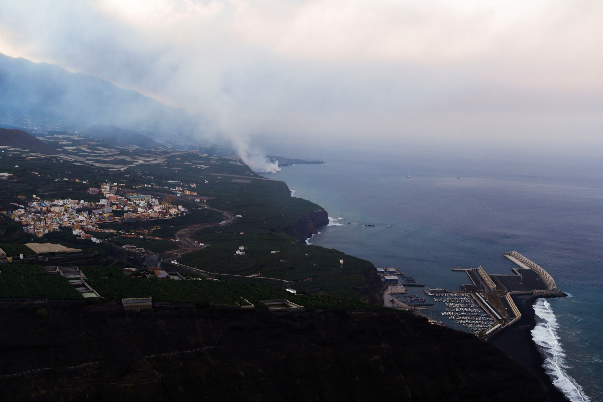Lava flows into the sea, as seen from Tijarafe, following the eruption of a volcano on the Canary Island of La Palma, Spain, September 29, 2021. REUTERS/Borja Suarez
