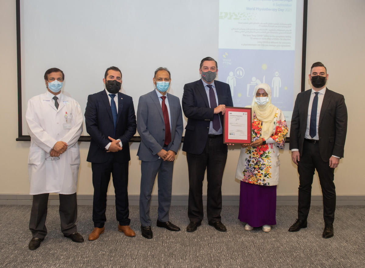 British Ambassador to Qatar H E Jon Wilks presenting ISO accreditation certificate to Executive Director of Nursing Informatics Department Dr. Wasmiya Dalhem Al Kuwari. 