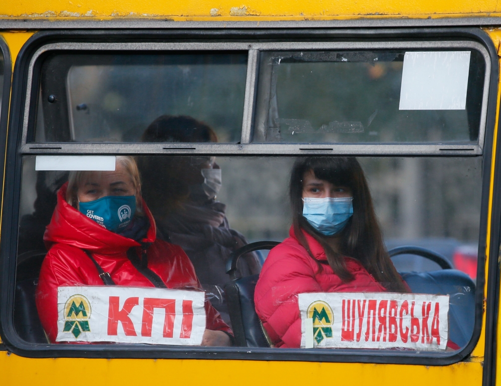 People wear protective face masks sit in a bus amid the ongoing coronavirus disease (COVID-19) outbreak in central Kyiv, Ukraine September 29, 2021. REUTERS/Gleb Garanich