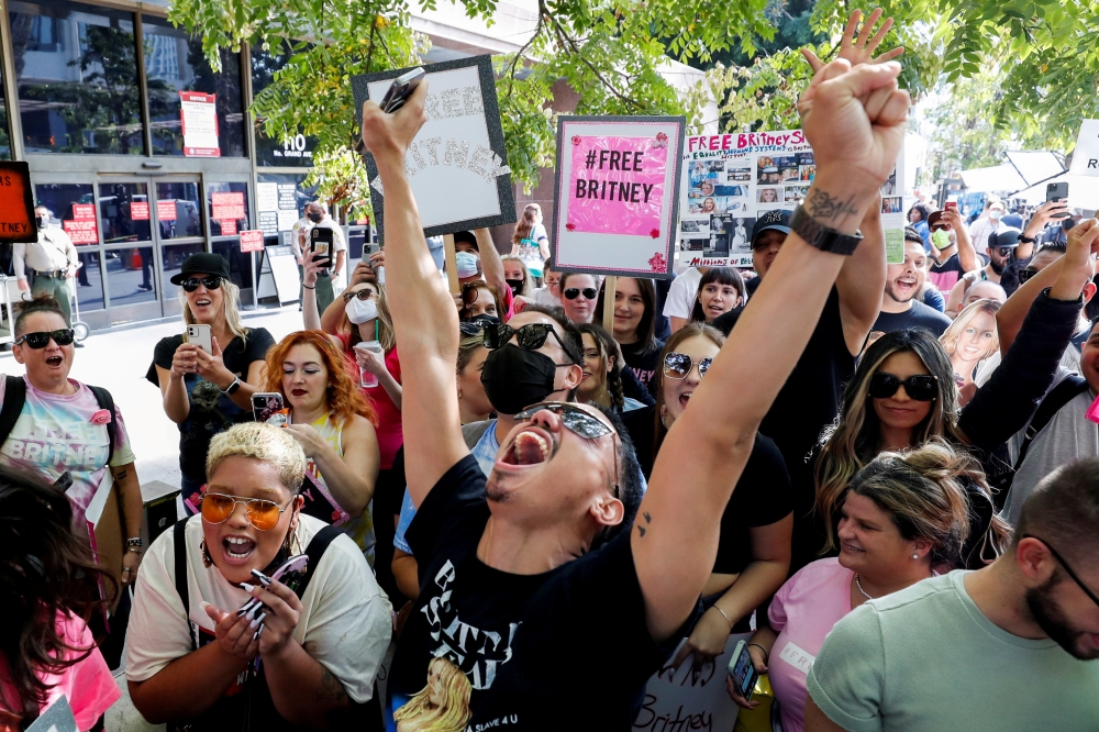 Supporters of pop star Britney Spears celebrate after a judge suspended the father of Britney Spears from his 13-years-long role as the controller of the singer's business affairs at Stanley Mosk Courthouse in Los Angeles, California, U.S., September 29, 