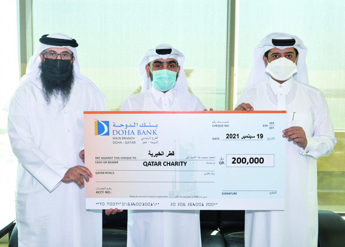Officials from Doha Bank and Qatar Charity during the bank’s presentation of its QR200,000 cash donation, in Doha, recently. 