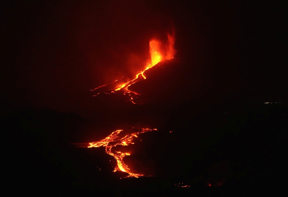 The Cumbre Vieja volcano continues to erupt on the Canary Island of La Palma, as seeen from the sea, Spain, October 3, 2021. REUTERS/Juan Medina