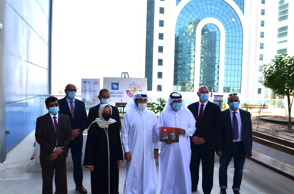 Officials from MME and Qatar Cool during the tree plantation event.