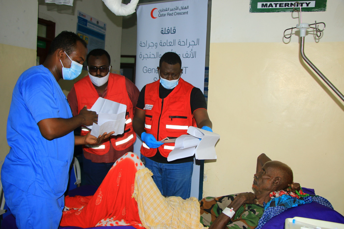 QRCS officials with a patient during an outreach programme in Somalia.