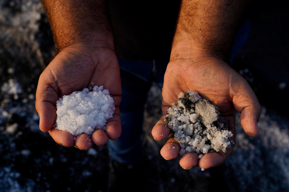 Andres Hernandez, manager of salt flats Salinas de Teneguia, shows how were damaged by the action of the ashes caused by the eruption of the Cumbre Vieja volcano in Fuencaliente, on the Canary Island of La Palma, Spain, October 7, 2021. Picture taken Octo