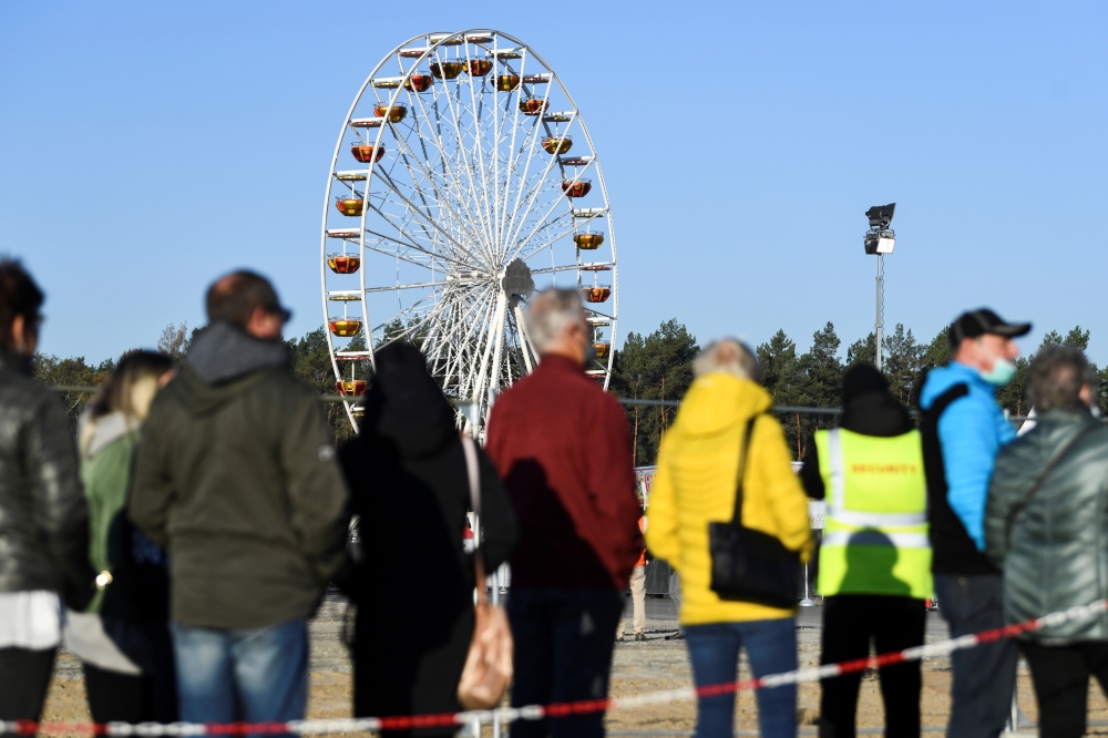 Invited guests arrive for a party with county fair and factory tour on the construction site of Tesla's electric car factory in Gruenheide, near Berlin, Germany, October 9, 2021. Reuters/Annegret Hilse