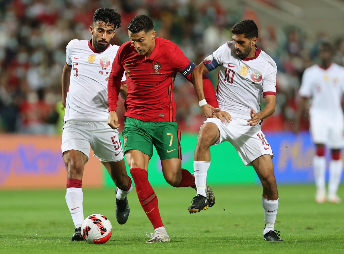 Qatar captain Hassan Al Haydos (right) in action during the match on Saturday.
