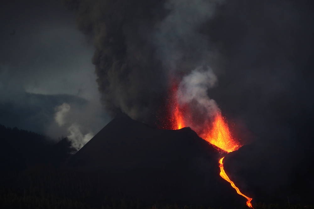The Cumbre Vieja volcano spews lava and smoke as it continues to erupt on the Canary Island of La Palma, as seen from Tacande, Spain, October 12, 2021. REUTERS/Sergio Perez