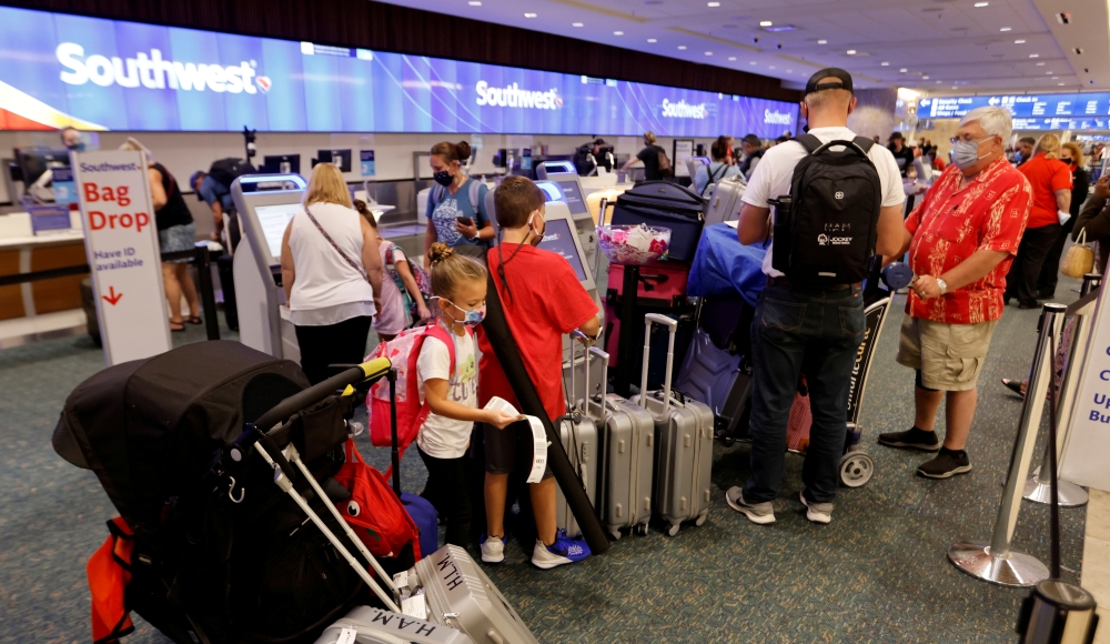 Passengers check in for a Southwest Airlines flight at Orlando International Airport in Orlando, Florida, U.S., October 11, 2021. REUTERS/Joe Skipper
