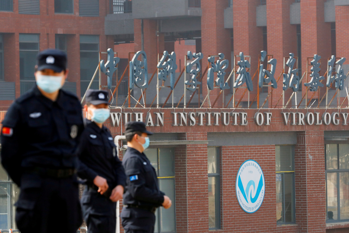 FILE PHOTO: Security personnel keep watch outside Wuhan Institute of Virology during the visit by the World Health Organization (WHO) team tasked with investigating the origins of the coronavirus disease (COVID-19), in Wuhan, Hubei province, China Februar