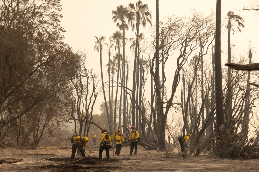 Firefighters extinguish hot spots from the Alisal fire near Refugio State Beach in Santa Barbara County, California, U.S., October 13, 2021. Picture taken October 13, 2021. REUTERS/Aude Guerrucci
