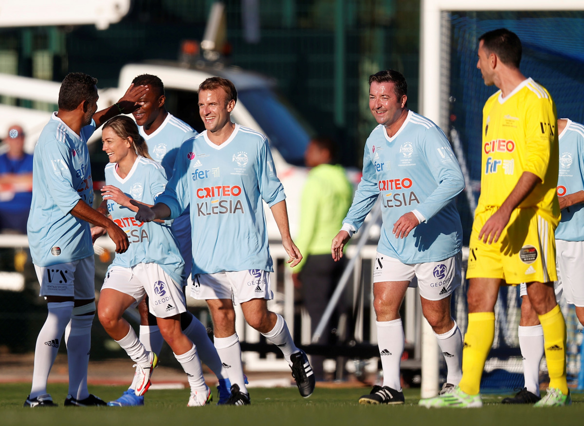 French President Emmanuel Macron celebrates a penalty goal as he participates in the Varietes Club gala football match marking the club's 50th anniversary, in Leo Lagrange stadium in Poissy, outside Paris, France October 14, 2021. Ian Langsdon/Pool via RE